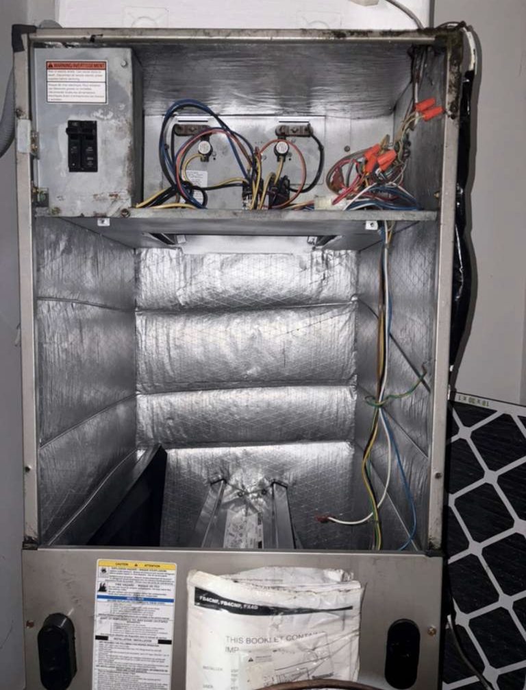 Open air handler cabinet with its wiring and insulated interior exposed